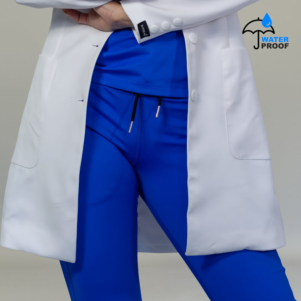 Close-up of women’s white lab coat lower pockets buttons and S-FOR-ME sleeve label