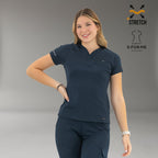 Women’s navy blue 905 scrub top front view with hand on hip