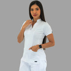 Women's white Style 930 scrub top, front view, model with one hand near the collar.
