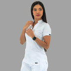 Women's white Style 930 scrub top, front view, model adjusting the neckline.