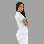 Women's white Style 930 scrub top, side profile view, model with arms crossed.