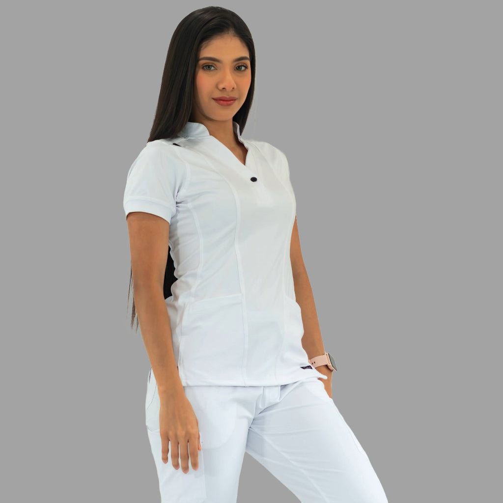 Women's white Style 930 scrub top, three-quarter view, model with hands near pockets.