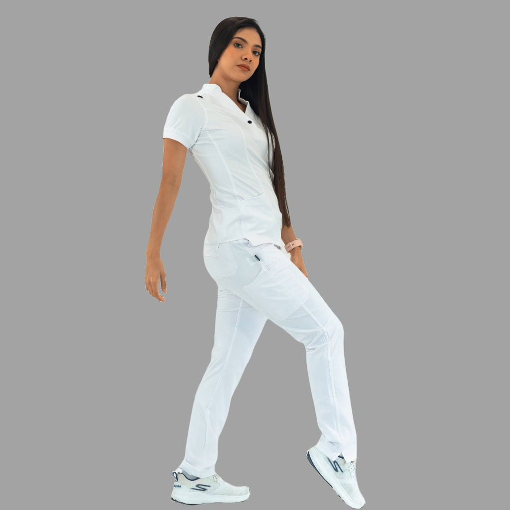 Women's white Style 930 scrub top and pants, full body view, model stepping forward.