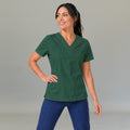 Women's bottle green lightweight scrub top 502 V-neck with hand on hip — fluid-resistant medical uniform for nurses by S-FOR-ME