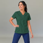 Women's bottle green lightweight scrub top 502 V-neck with hand on hip — fluid-resistant medical uniform for nurses by S-FOR-ME