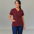 Women's maroon lightweight scrub top 502 V-neck with hand on hip — fluid-resistant medical uniform for nurses by S-FOR-ME