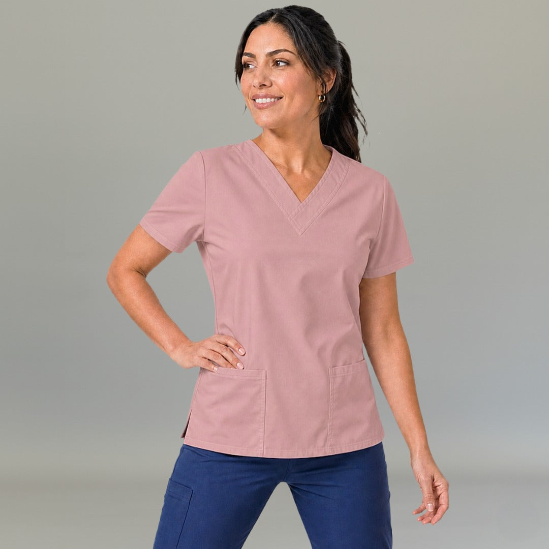 Women's dusty pink lightweight scrub top 502 V-neck with hand on hip — fluid-resistant medical uniform for nurses by S-FOR-ME