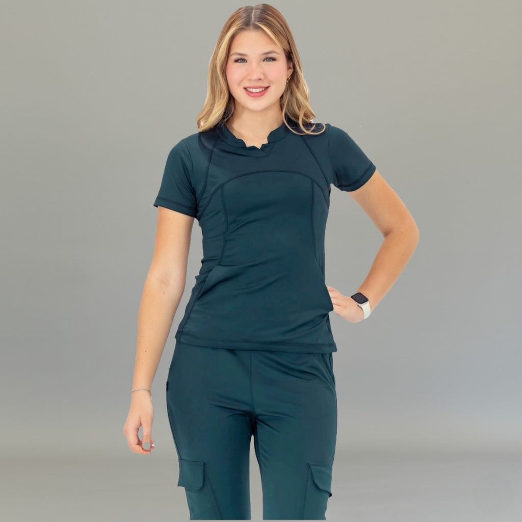 Front view of airforce blue scrub top on model standing with hands relaxed.