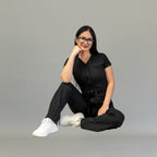 Seated pose in women’s Black Super Stretch scrub jumpsuit