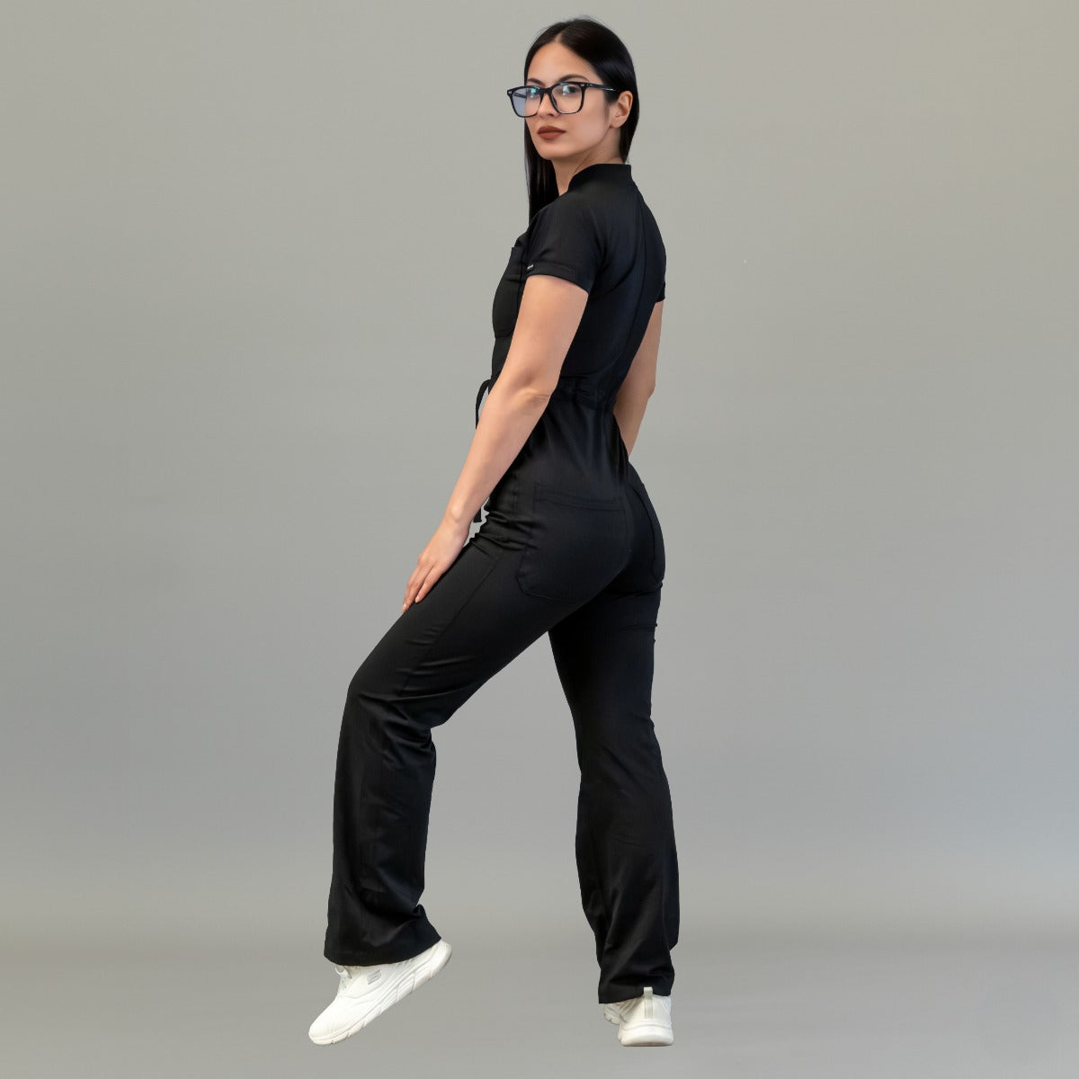 Three-quarter back view of women’s Black Super Stretch scrub jumpsuit
