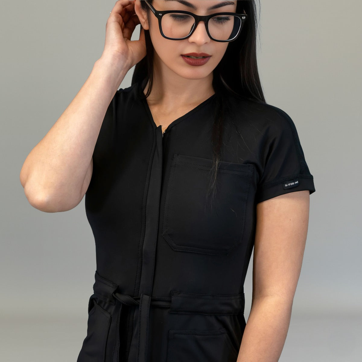 Front zipper, short sleeve and waist tie detail on Black scrub jumpsuit