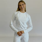 Front view of white super stretch long sleeve underscrub with hands together.