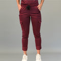 Front view of maroon jogger scrub pants with cargo pockets and elastic waistband.
