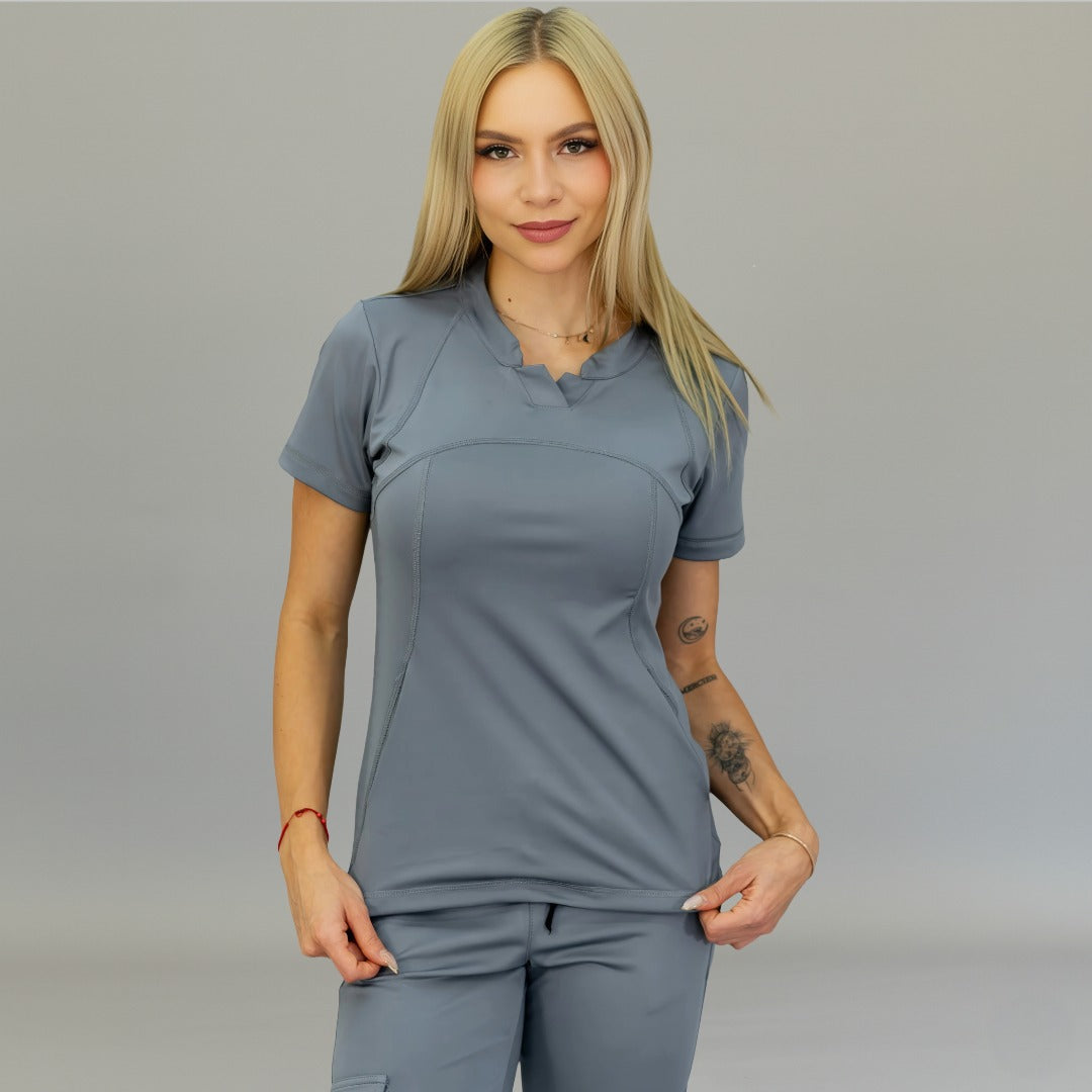 Front view of medium gray Top 910 super stretch scrubs with model pulling the hem.