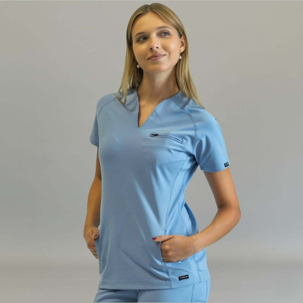 Women’s sky blue scrub top, three-quarter view looking right