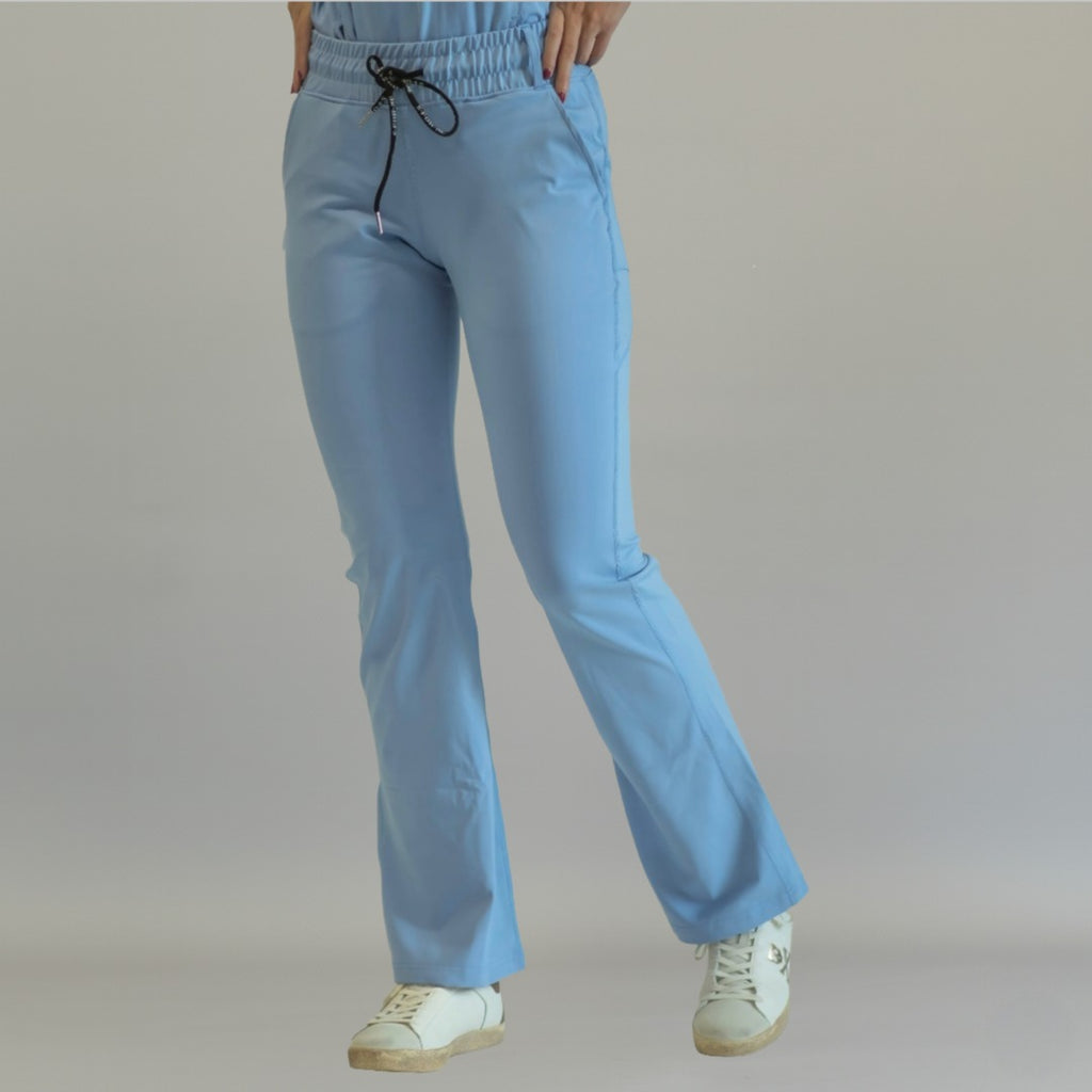 Women's sky blue flare scrub pants, front view with one leg forward
