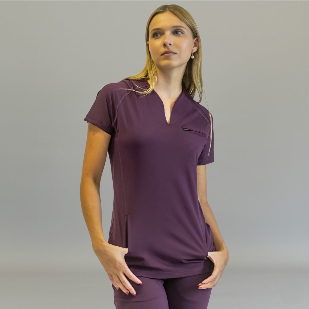 Women's purple scrub top, Style 915, front view with model's hands in pockets