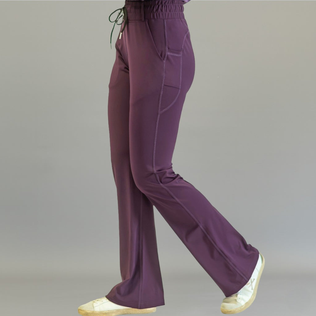 Women's Style 915 purple flare scrub pants, side profile view showing stretch fit