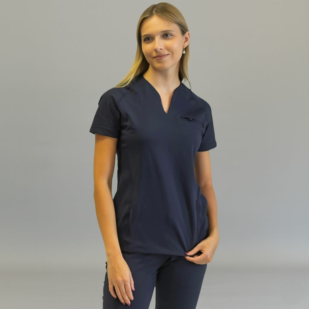 Women's Style 915 navy blue scrub top, front view, hands on hem