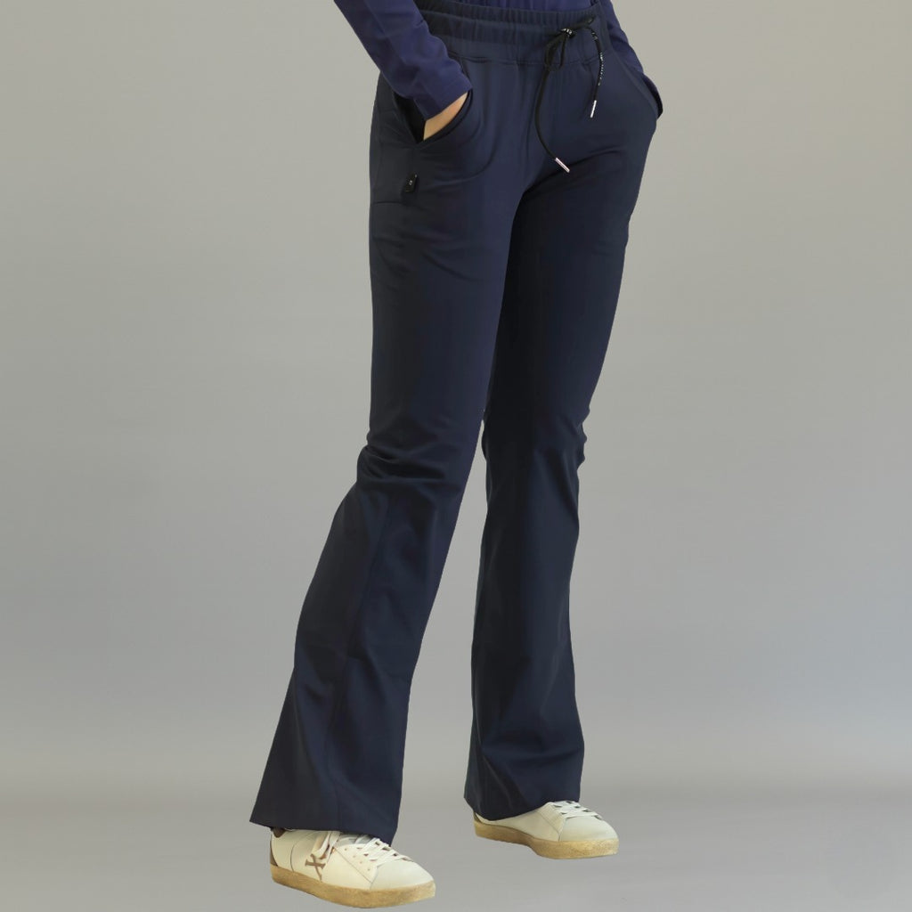 Women's navy blue flare scrub pants, front view walking