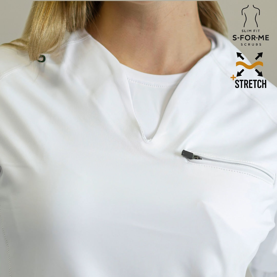 Women's 915 White scrub top — seated pose showing stretch and comfort during long shifts