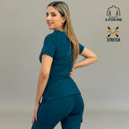 Back angle of women's corsair blue scrub top style 901 looking over the shoulder.