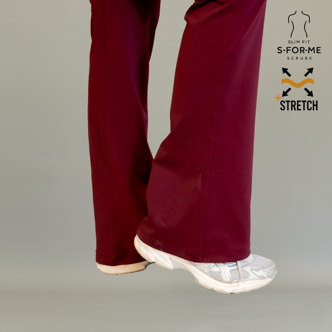 Close-up of maroon flare scrub pants model 915 showing relaxed flare leg over white shoe